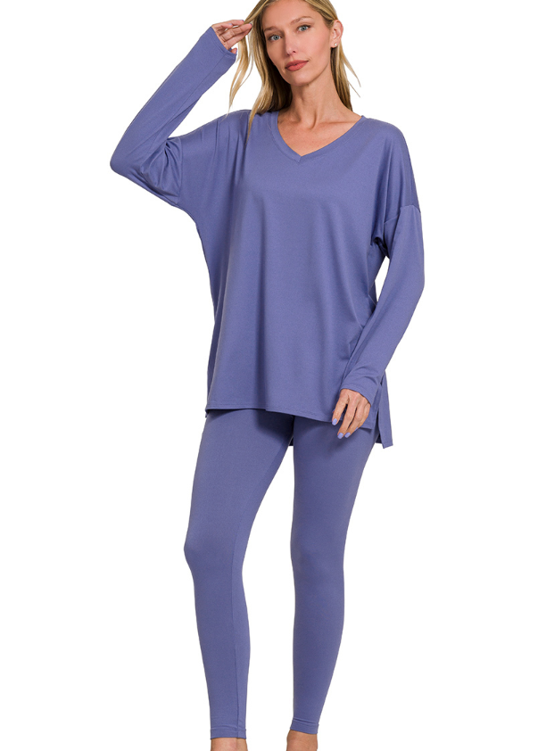 Woman wearing a purple loungewear set on a white background