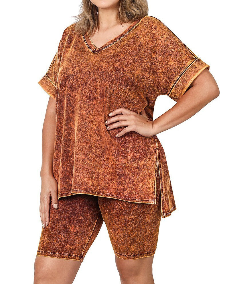 Woman wearing a matching top and shorts set in golden mustard color on a white background